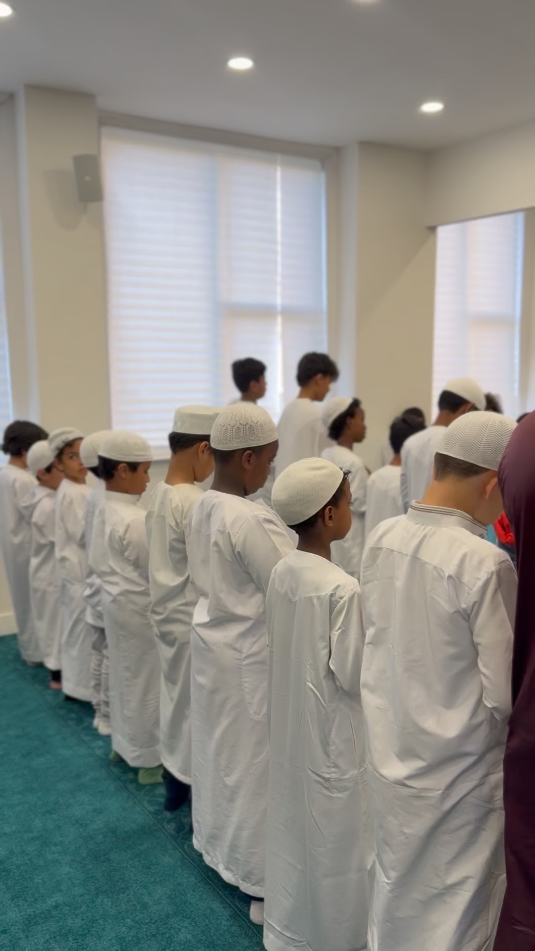 Students standing in rows for prayer